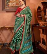 green patola silk blend saree with traditional motifs & zari/contrast border | unstitched blouse