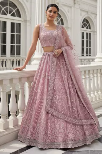 Entrancing Baby Pink Dori, Multi Thread, Sequence Embroidered and Zircon Diamond Heavy Net Wedding Lehenga Choli