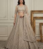 Mesmerizing Golden Dori, Zari, Thread,Sequence Embroidered and motif work Heavy net bridal wear lehenga choli