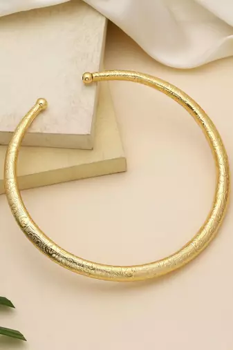 Gold color amrapali hansli necklace crafted with traditional detailing for elegant festive wear