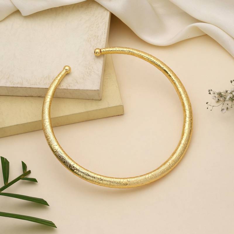 Gold color amrapali hansli necklace crafted with traditional detailing for elegant festive wear