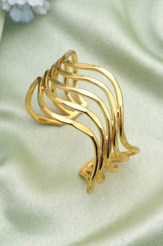 Gold color bracelet created with artistic detailing to enhance festive looks with radiant appeal