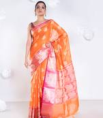 banarasi organza saree in burnt orange color with floral motifs and contrasting border