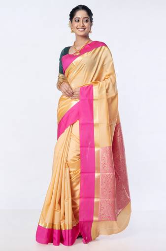 kanjivaram saree in beige color with contravention border and zari motifs
