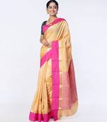 kanjivaram saree in beige color with contravention border and zari motifs