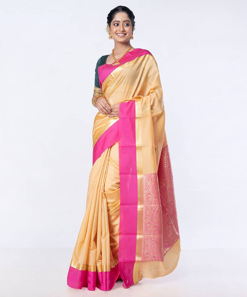 kanjivaram saree in beige color with contravention border and zari motifs