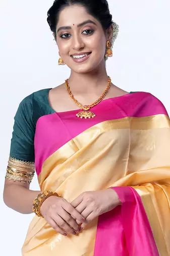kanjivaram saree in beige color with contravention border and zari motifs