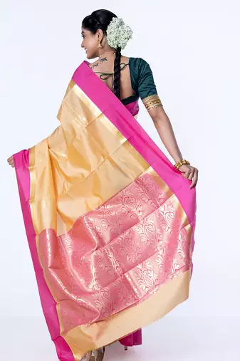 kanjivaram saree in beige color with contravention border and zari motifs