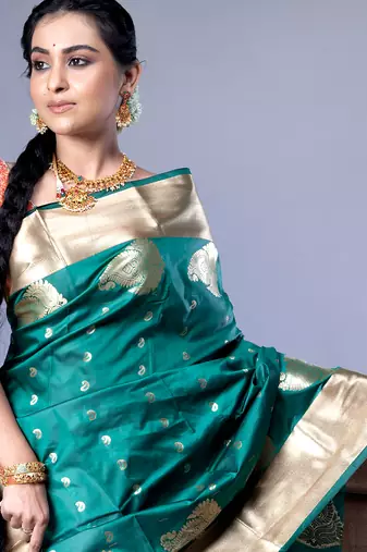 kanjivaram saree in bottle green color with golden border and booti