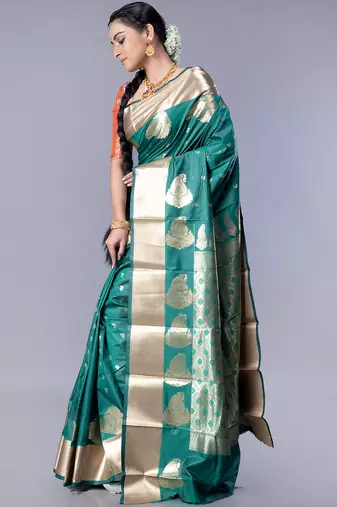 kanjivaram saree in bottle green color with golden border and booti