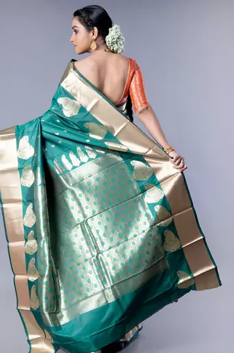 kanjivaram saree in bottle green color with golden border and booti