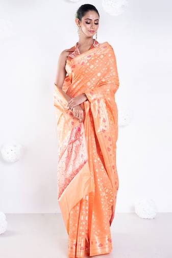 Banarasi kora organza saree in orange color with golden booti and border