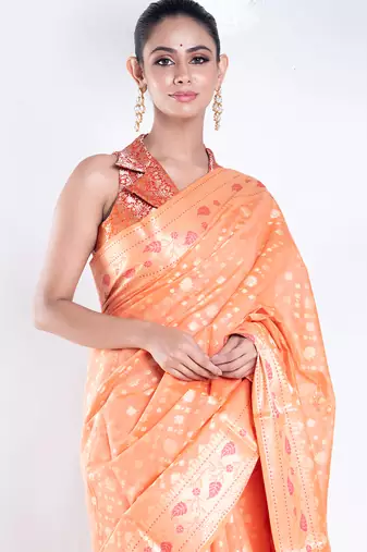 Banarasi kora organza saree in orange color with golden booti and border