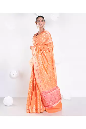 Banarasi kora organza saree in orange color with golden booti and border