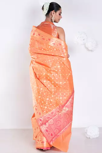 Banarasi kora organza saree in orange color with golden booti and border
