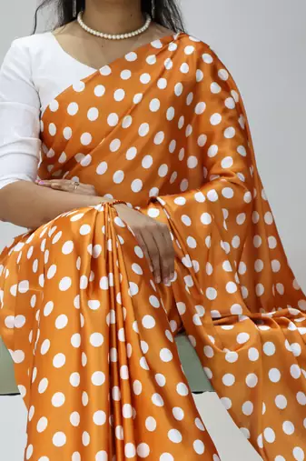 orange color polka dots print heavy japan satin saree with unstitched blouse