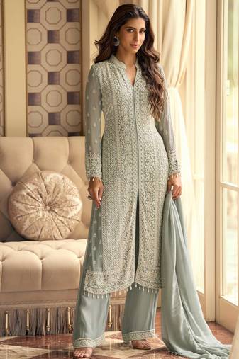 Sea green georgette front-slit kurti palazzo with white thread work zari highlights sequins and embroidered borders.