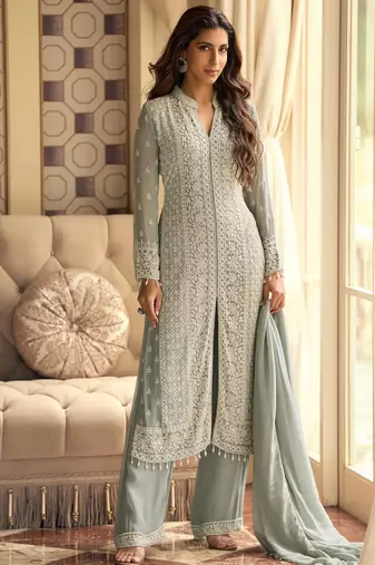 Sea green georgette front-slit kurti palazzo with white thread work zari highlights sequins and embroidered borders.