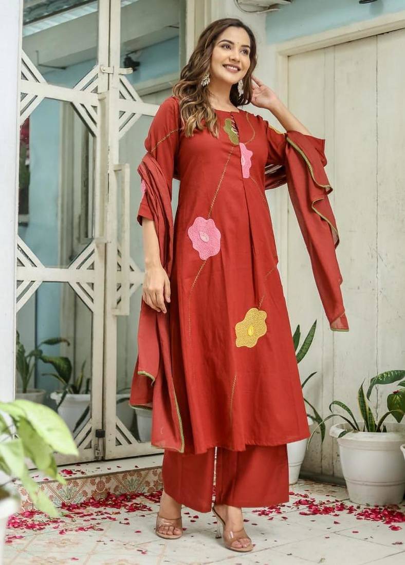 Beautiful jaipuri a rust orange cotton kurta, pant, and dupatta set with floral applique designs and orange piping.