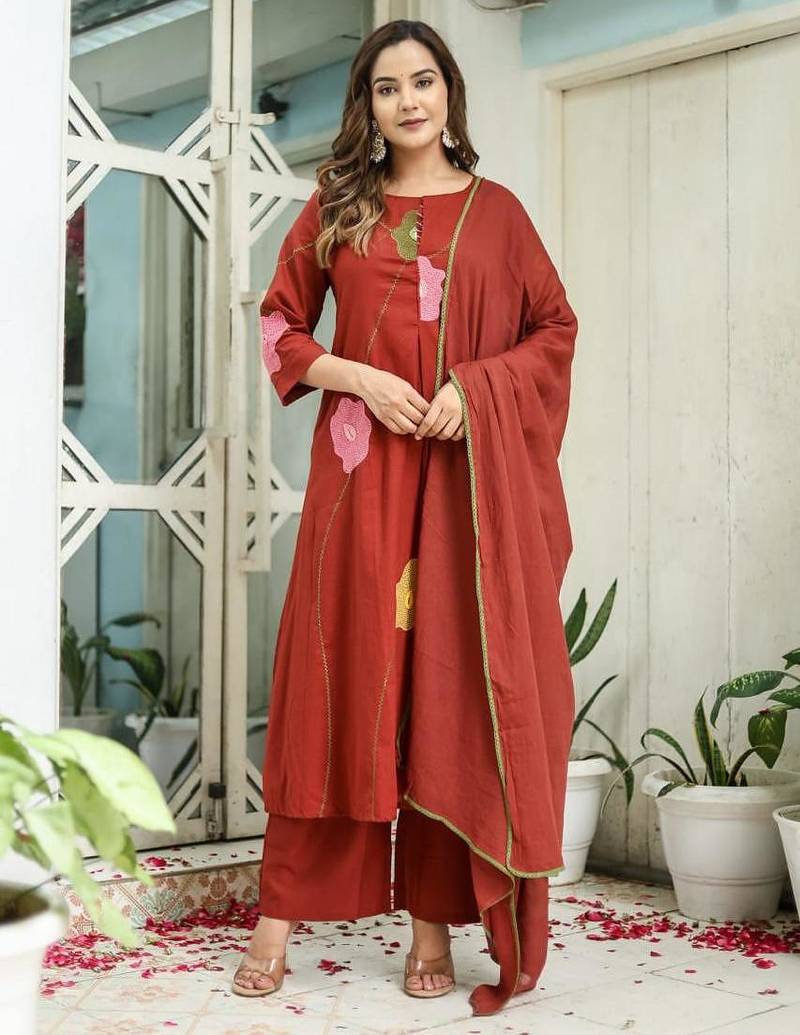 Beautiful jaipuri a rust orange cotton kurta, pant, and dupatta set with floral applique designs and orange piping.