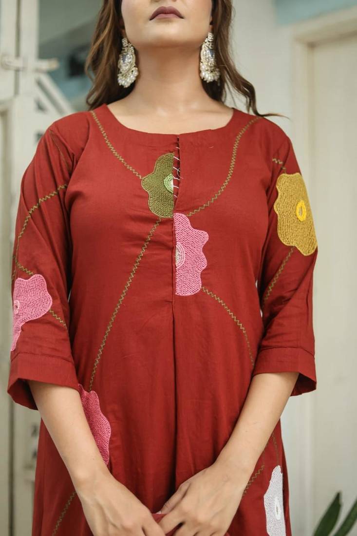 Beautiful jaipuri a rust orange cotton kurta, pant, and dupatta set with floral applique designs and orange piping.