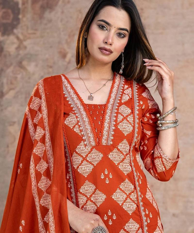 Beautiful jaipuri a rust orange cotton kurta, pant, and dupatta set with floral applique designs and orange piping.