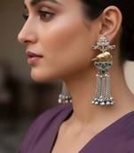Rani & green color oxidised earrings offering dual-tone contrast ideal for bold cultural fashion