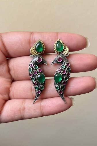 Green color oxidised earrings styled with dual-tone textures to enrich festive ethnic clothing