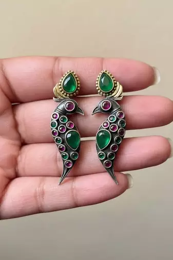 Green color oxidised earrings styled with dual-tone textures to enrich festive ethnic clothing