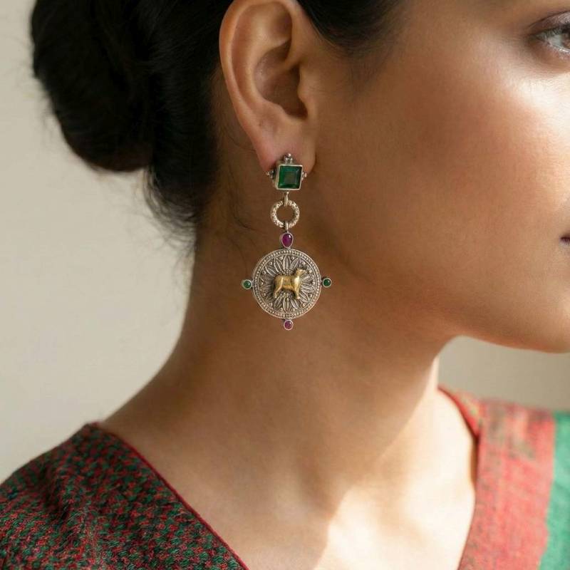 Green color oxidised earrings designed in dual-tone finish bringing refined festive sophistication