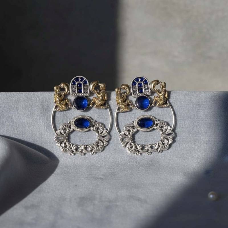 Blue color oxidised earrings designed with stunning dual-tone detailing for bold festive fashion