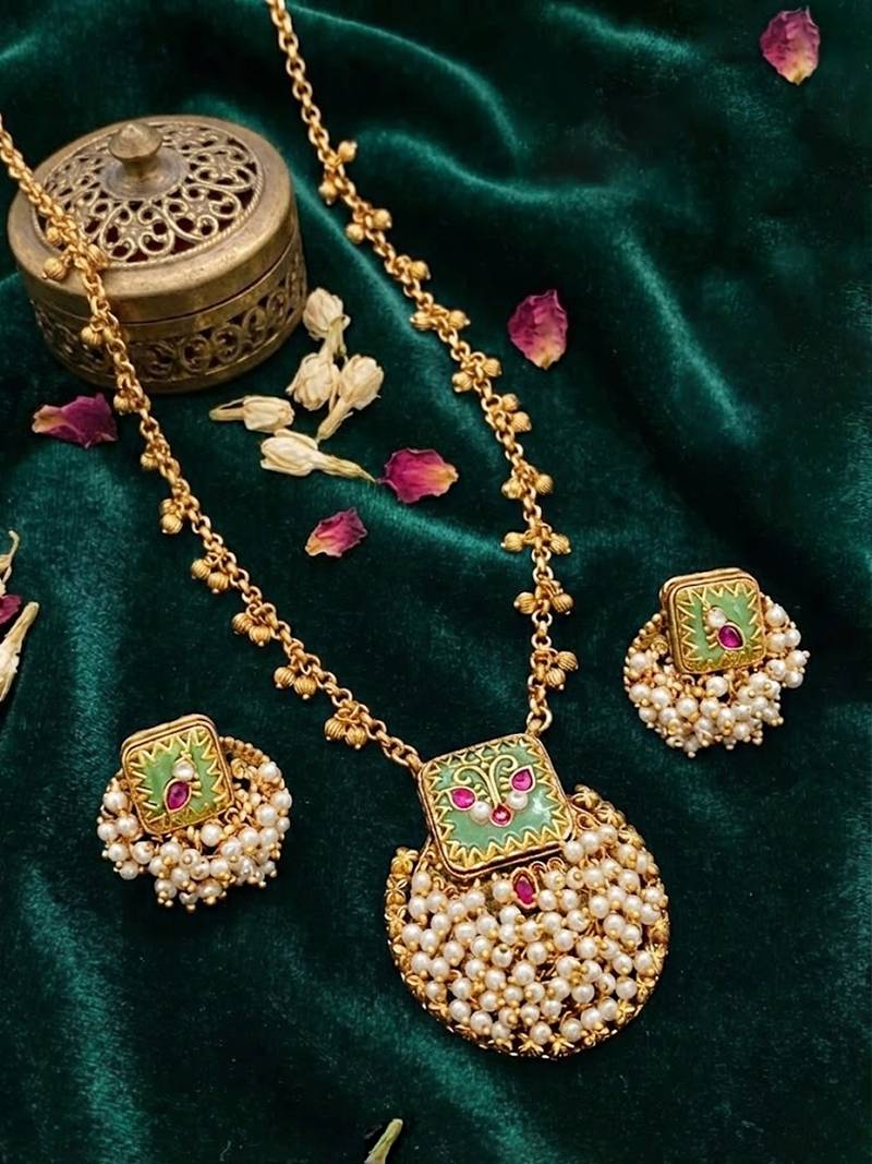 Gold finish pendant necklace set with kundan polki and ruby stones