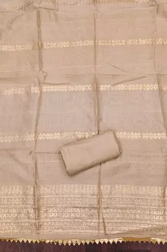 Beige woven shimmer churidar dress-materials
