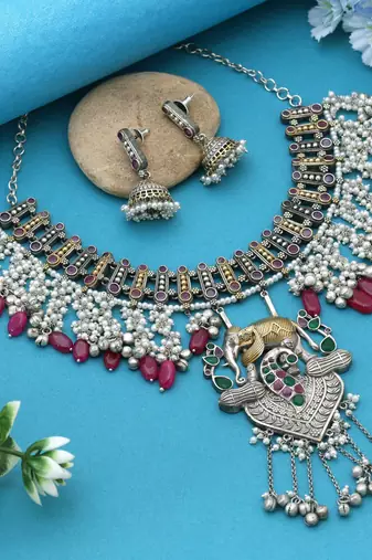 Rani & green color dual tone oxidised necklace set offering regal tones with ornate craftsmanship