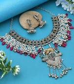 Rani & green color dual tone oxidised necklace set offering regal tones with ornate craftsmanship