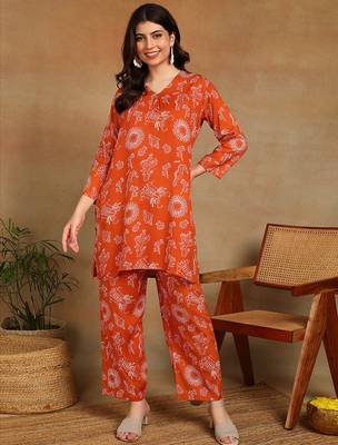 Women ethnic motifs printed orange rayon straight kurta with pants set 1