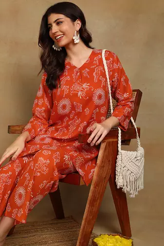 Women ethnic motifs printed orange rayon straight kurta with pants set