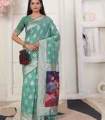 rama green color woven linen cotton flower & peacock pallu saree