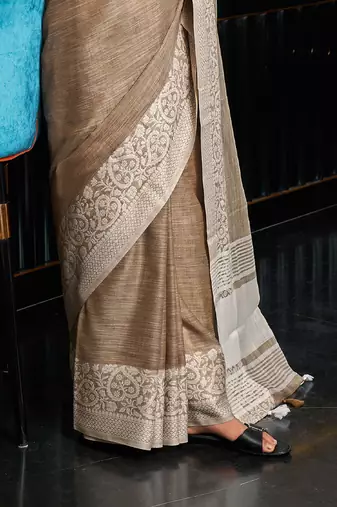 beige color solid zari border linen cotton saree