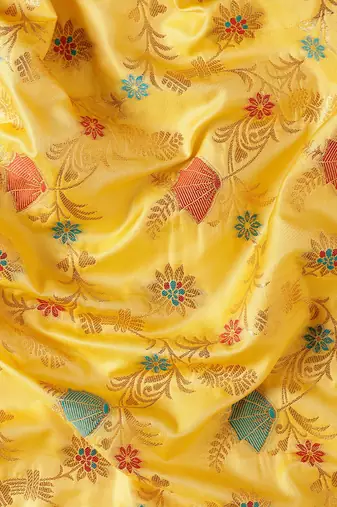 Graceful yellow banarasi silk blend saree with golden zari woven border & floral jaal     wedding & festive wear