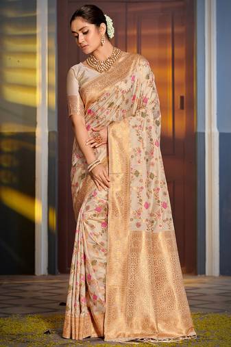 Graceful white banarasi silk blend saree with golden zari woven border & floral jaal     wedding & festive wear
