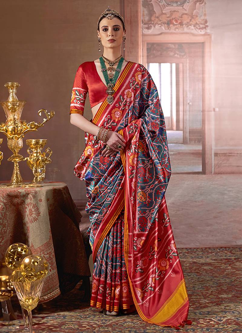 teal art silk blend patola print saree with red blouse