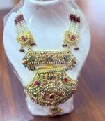 Golden necklace with green stone work  and kundan work