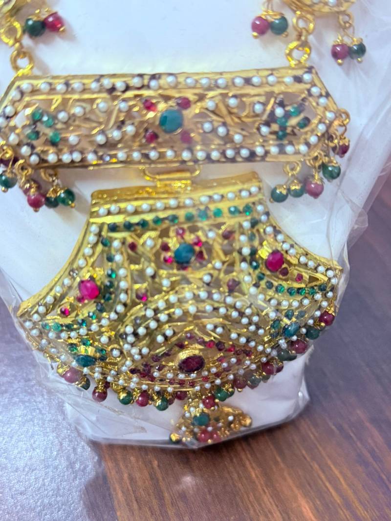 Golden necklace with green stone work  and kundan work