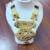 Golden necklace with green stone work  and kundan work