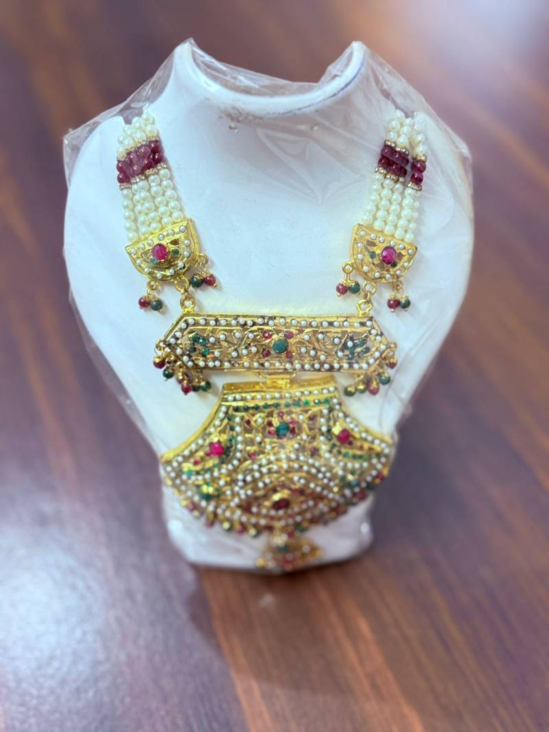 Golden necklace with green stone work  and kundan work