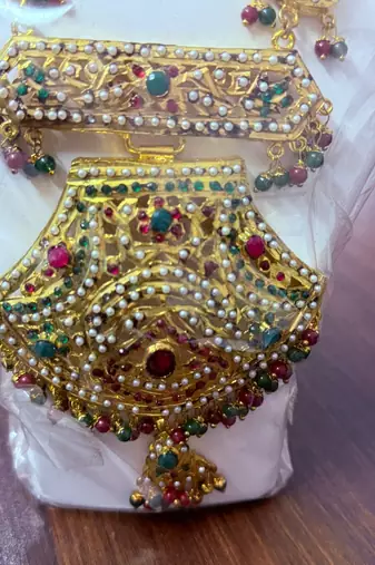 Golden necklace with green stone work  and kundan work