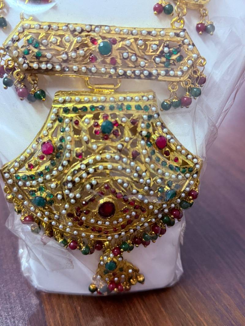 Golden necklace with green stone work  and kundan work