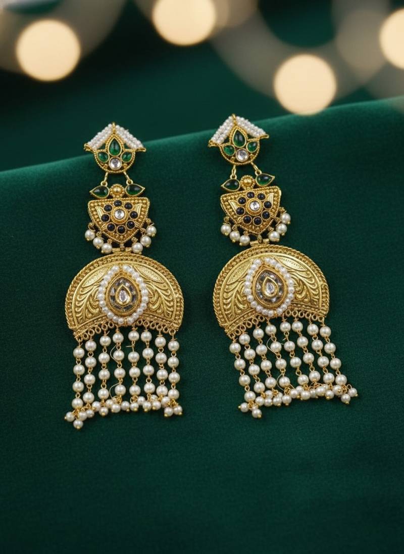 Gold plated kundan temple earrings with pearl tassels & green stone