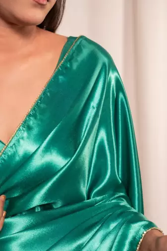 bottle green cutdana border satin embroidered saree with stitched blouse